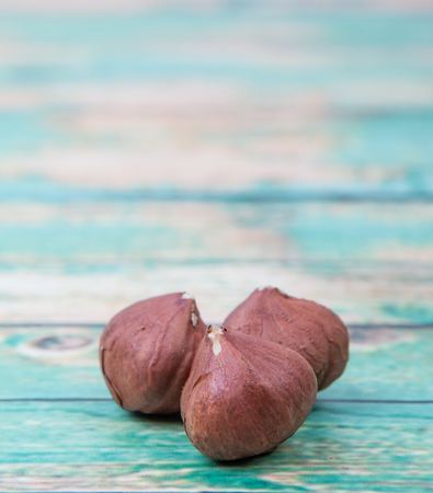Peeled hazelnut nut over wooden backgroundの写真素材