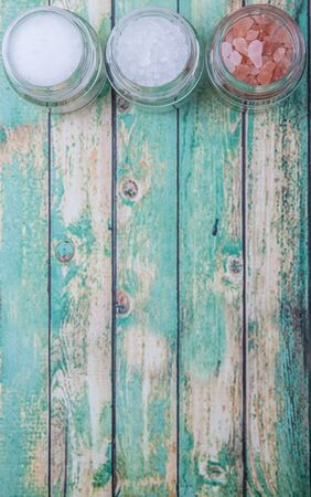 Table salt, sea salt and himalayan salt in mason jar over wooden backgroundの写真素材
