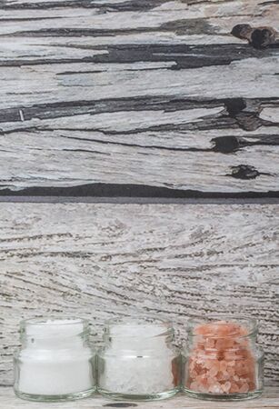 Table salt, sea salt and himalayan salt in mason jar over wooden backgroundの写真素材
