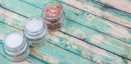 Table salt, sea salt and himalayan salt in mason jar over wooden backgroundの写真素材