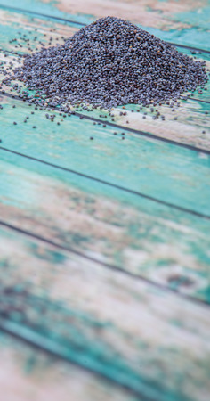 Black poppy seeds over wooden backgroundの写真素材