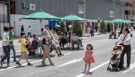 GINZA,TOKYO, JAPAN - MAY 6TH, 2016. Tourists and locals walking in Ginza Street, an upscale and...