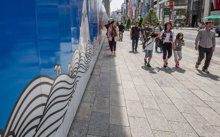GINZA,TOKYO, JAPAN - MAY 6TH, 2016. Tourists and locals walking in Ginza Street, an upscale and...