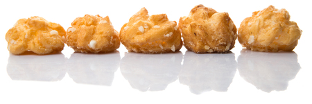 Choux pastry sprinkled with sugar over white background