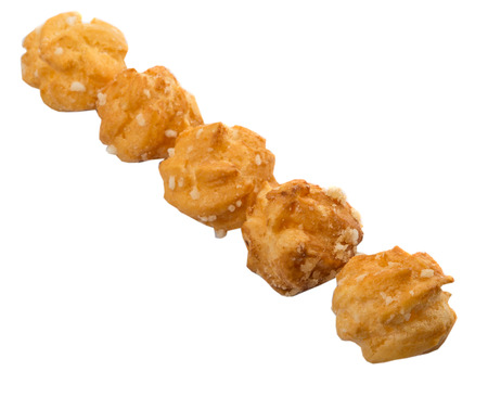 Choux pastry sprinkled with sugar over white background