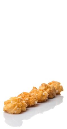 Choux pastry sprinkled with sugar over white backgroundの写真素材