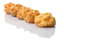 Choux pastry sprinkled with sugar over white backgroundの写真素材