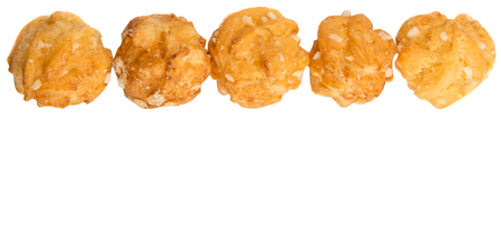 Choux pastry sprinkled with sugar over white background