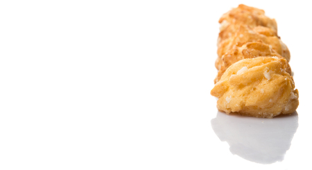 Choux pastry sprinkled with sugar over white backgroundの写真素材