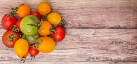 Colorful cherry tomatoes over wooden backgroundの写真素材