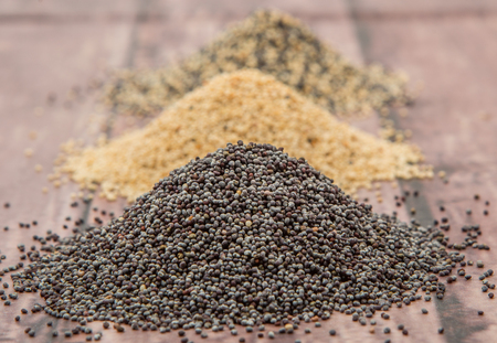 White poppy seed, black poppy seed and mix poppy seed over wooden backgroundの写真素材