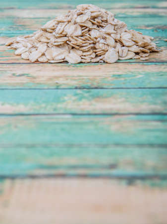 Raw oatmeal over wooden backgroundの写真素材