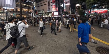 TOKYO, JAPAN - MAY 21ST, 2016. Crowd of people at the popular Shibuya Crossing junction at night...