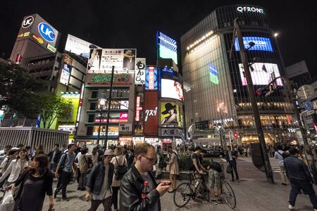 TOKYO, JAPAN - MAY 21ST, 2016. Crowd of people at the popular Shibuya Crossing junction at night time. Shibuya is a popular shopping district in Tokyo, Japan.のeditorial素材