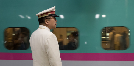 TOKYO, JAPAN - MAY 30TH, 2016. Tokyo Railway Station officials working at the Tokyo Station...