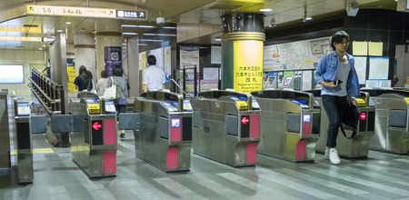TOKYO, JAPAN - MAY 31ST, 2016. Cleaners getting ready to clean Japan bullet train coach in Tokyo...