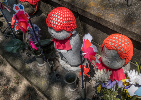 TOKYO, JAPAN - JUNE 2ND 2016Little children statues represent unborn children, including miscarried, aborted, and stillborn in Zojoji Temple, Tokyo. Parents can decorate these statues with clothing and toysのeditorial素材