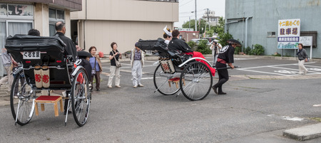 ITAKO, IBARAKI, JAPAN - JUNE 4TH 2016. Japanese bride and groom in traditional costume in rickshaw during the annual Suigi Itako Iris Flower Festival.のeditorial素材