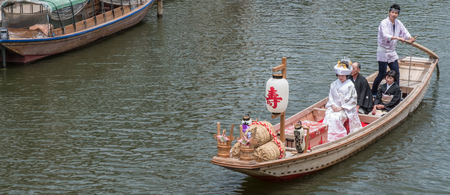 ITAKO, IBARAKI, JAPAN - JUNE 4TH 2016. The Bridal Boat or Yomeiribune, a Japanese bride boarding a wooden boat in traditional costume during the annual Suigo Itako Iris Flower Festival.のeditorial素材