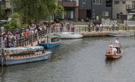 ITAKO, IBARAKI, JAPAN - JUNE 4TH 2016. Locals and tourist riding a wooden boat at  the annual Suigo Itako Iris Flower Festival.のeditorial素材