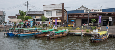 ITAKO, IBARAKI, JAPAN - JUNE 4TH 2016. Locals and tourist riding a wooden boat at  the annual Suigo Itako Iris Flower Festival.のeditorial素材