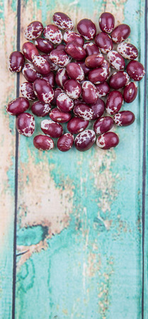 Pinto beans or speckled beans over wooden background