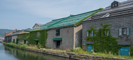 OTARU CITY, JAPAN - AUGUST 1ST, 2016. Old stone warehouses lining up Otaru Canal in Otaru City, Japan. Otaru is popular tourist destination and a port city in the island of Hokkaido, Japan.のeditorial素材