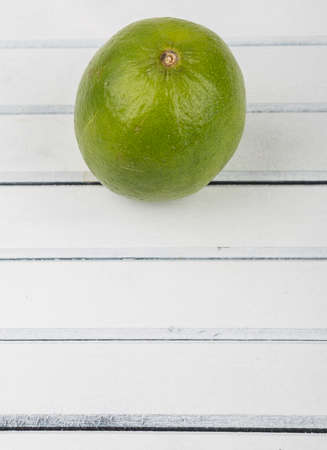Fresh lime fruit over wooden backgroundの写真素材