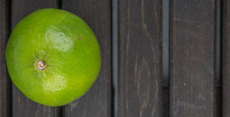Fresh lime fruit over wooden backgroundの写真素材