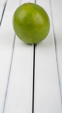Fresh lime fruit over wooden backgroundの写真素材