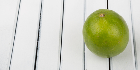 Fresh lime fruit over wooden backgroundの写真素材