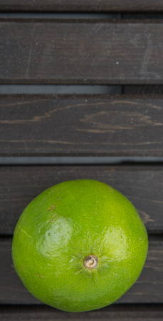 Fresh lime fruit over wooden backgroundの写真素材