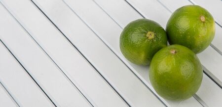 Fresh lime fruit over wooden backgroundの写真素材