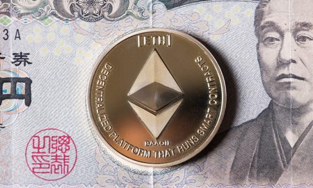 Ethereum coin cryptocurrency on Japanese Yen bank notes.