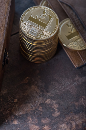 Litecoin with leather wallet on wooden table topの写真素材
