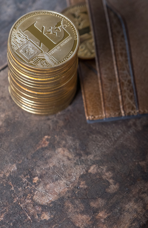 Litecoin with leather wallet on wooden table topの写真素材
