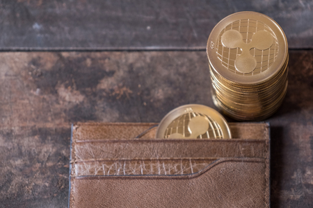 Ripple coin with lether wallet on wooden table topの写真素材