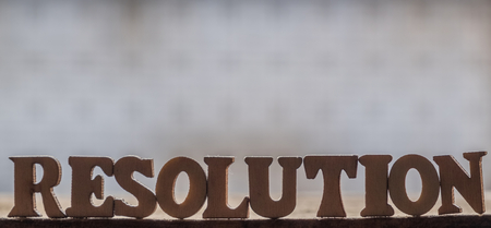 'RESOLUTION' text on wooden background.の写真素材