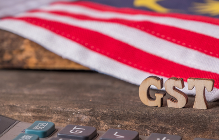 'GST' text with  calculator and Malaysian flag background.の写真素材