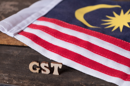 'GST' text with  calculator and Malaysian flag background.の写真素材