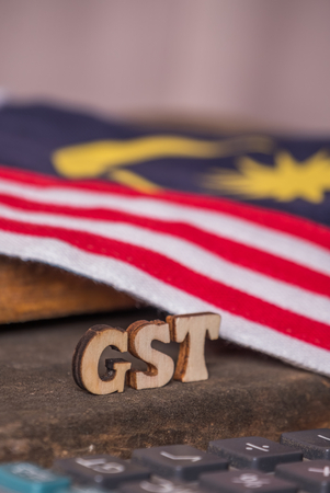 'GST' text with  calculator and Malaysian flag background.の写真素材