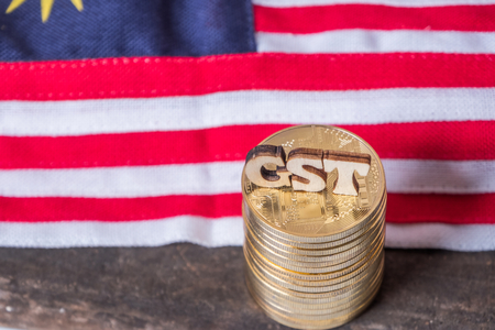 'GST' words with golden coins and Malaysian flag backgroundの写真素材