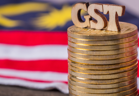 'GST' words with golden coins and Malaysian flag backgroundの写真素材