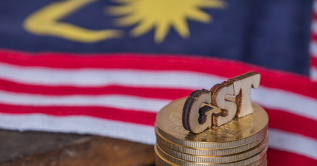 'GST' words with golden coins and Malaysian flag backgroundの写真素材