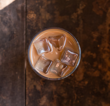 Iced milk coffee over wooden backgroundの写真素材