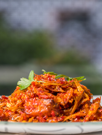 Malay dish stir fried chili with deep fried anchovies and potato cubes or locally known as ikan bilis goreng berlada.の写真素材