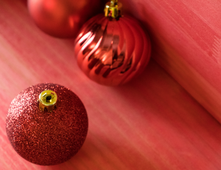 Christmas balls on over red wooden backgroundの写真素材