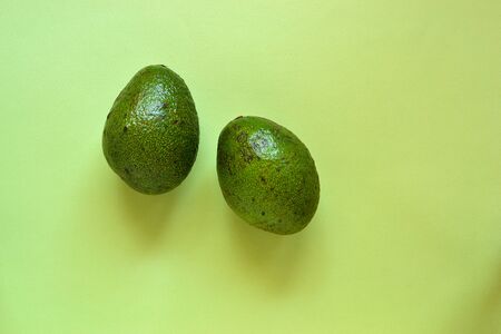 Cut avocado. Avocado on a pastel pink background. Free space for text. Top view. Flat lay....