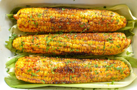 Baked corn. Spiced corn in a baking dish. Healthy vegan food. Closeup