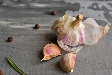 Garlic on a gray background. Healthy food. Free space for text.